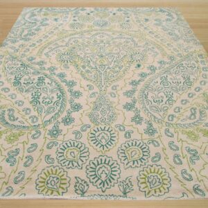 Cream high-pile rug featuring a large ornate floral and paisley design in teal and light green.