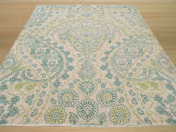 Cream high-pile rug featuring a large ornate floral and paisley design in teal and light green.