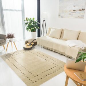 Low-pile beige rug with dark brown cross patterns borders a bright, neutral living space.