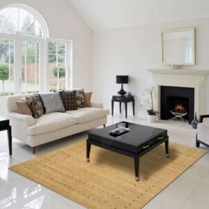 Tan low-pile rug with a dark geometric pattern defines the seating area on shiny white flooring.