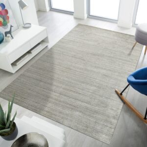 Low-pile heathered gray rug featuring horizontal striations in a brightly lit room with white furniture.