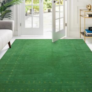 Solid green low-pile rug featuring a subtle yellow-green border in a sunlit white room with French doors.