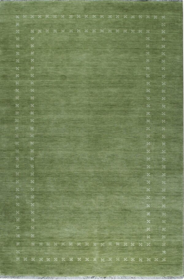 A moss green rug with a plain field and an inset border of small white geometric patterns.