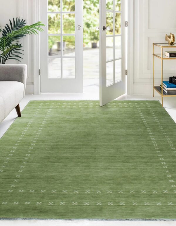 Textured low-pile green rug with minimalist white geometric patterns sits before bright french doors.