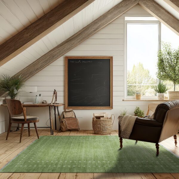 A green rug with white geometric accents anchors a leather armchair and wooden desk on plank floors.
