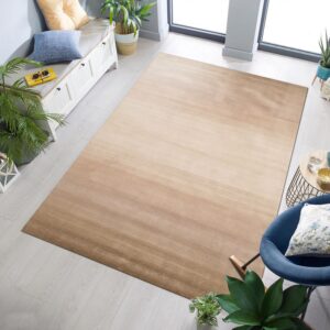 Low-pile rug with beige to brown striated shading covers light gray wood plank flooring.