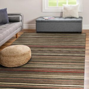 Earth-toned striped rug anchors a living space with a gray sofa and a woven pouf.