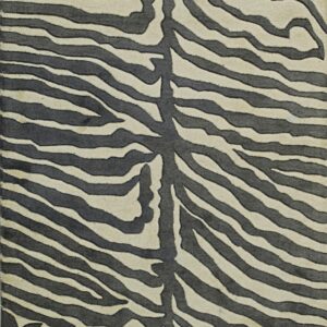Textured rug with a dark grey and cream zebra stripe pattern and dimensional carving detail.