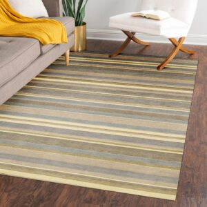 Low-pile striped rug in gray, taupe, and yellow tones anchors a living space on dark wood flooring.