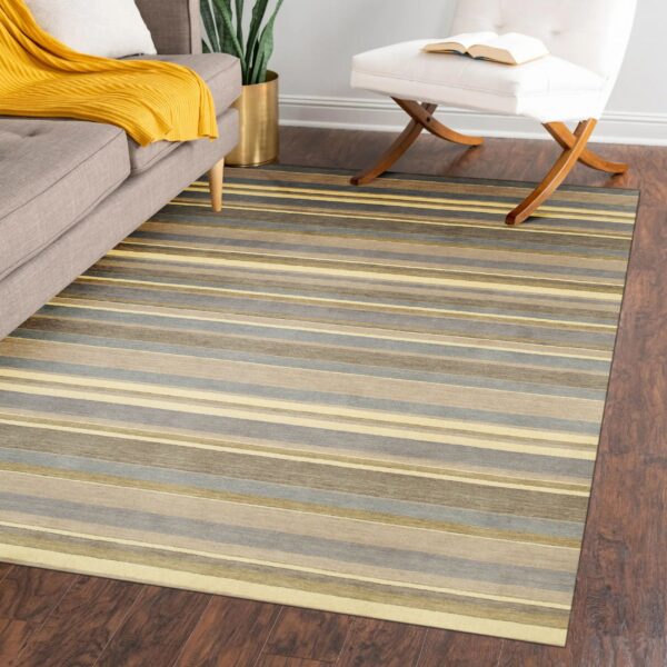 Low-pile striped rug in gray, taupe, and yellow tones anchors a living space on dark wood flooring.