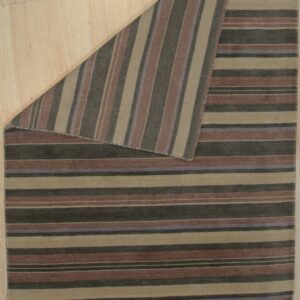 Multi-colored striped rug with horizontal stripes, folded to show vertical stripes on light wood flooring.