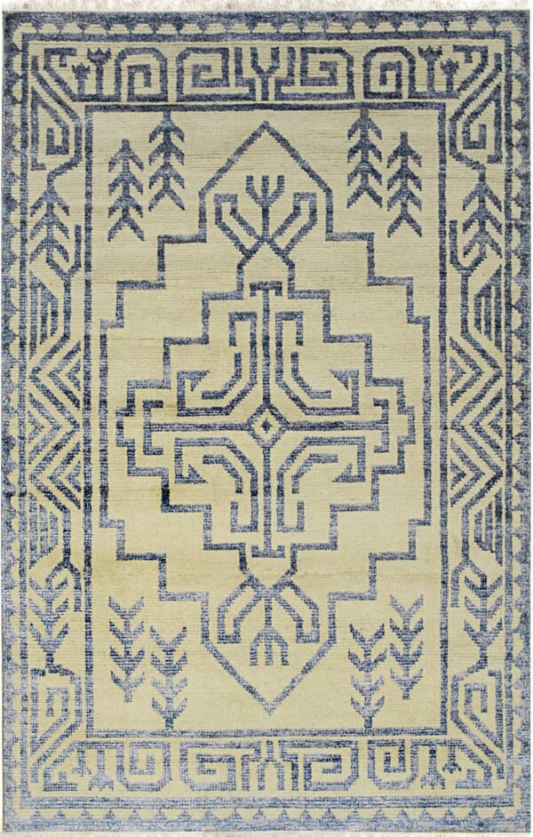 Beige rug featuring an angular blue geometric pattern, complex borders, and a large central stylized motif.