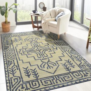 Cream and blue geometric rug under a white armchair in a bright room with large windows.