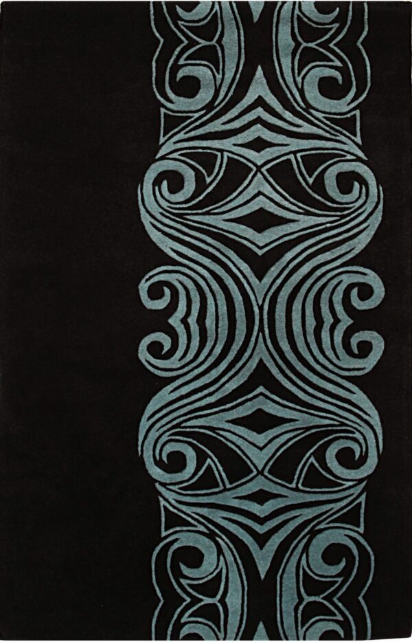 Close-up of a black rug showing a vertical teal border with deeply carved symmetrical scrollwork designs.
