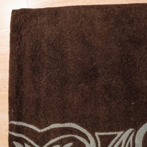 Textured dark brown rug featuring light blue curving lines rests on light blonde wood flooring.