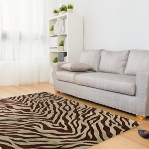A brown and tan zebra print rug is placed on wood floors near a light gray sofa.