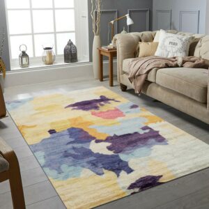 Low-pile abstract rug in purple, blue, yellow, and orange tones in a bright gray living room.