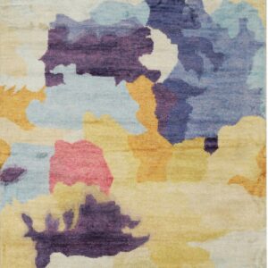A colorful rug featuring an abstract watercolor design of purple, blue, yellow, pink, and cream shapes.