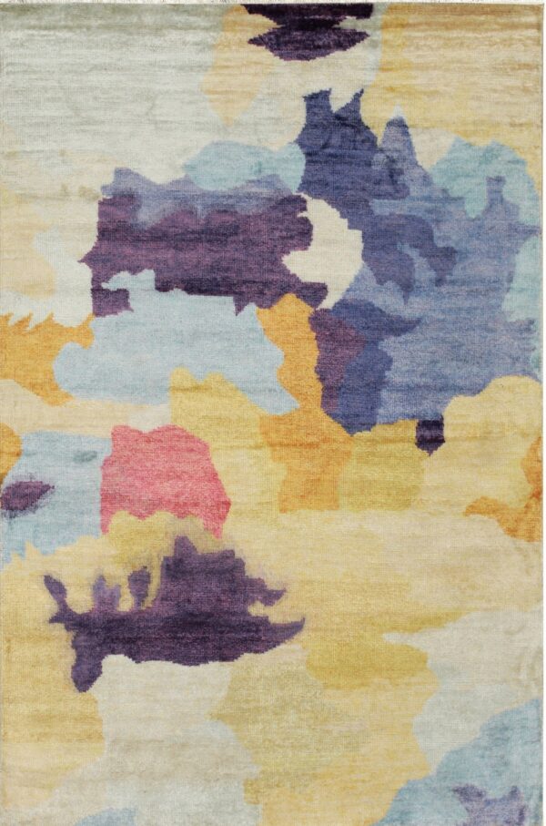 A colorful rug featuring an abstract watercolor design of purple, blue, yellow, pink, and cream shapes.
