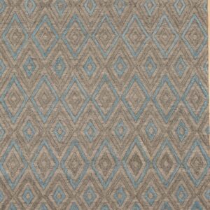 A textured rug displaying repeating gray and brown nested diamonds accented by turquoise geometric outlines.