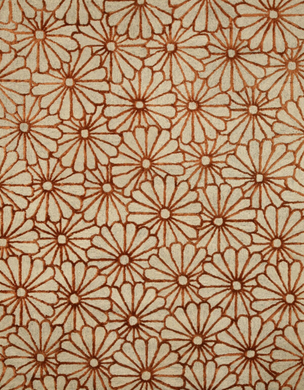 Close-up of a high-low pile rug with a repeating rust floral pattern on a beige background.
