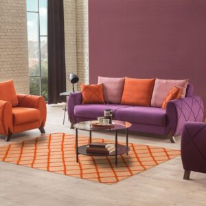 A flatweave orange and white concentric square rug anchors a purple and orange living room setup on wood flooring.