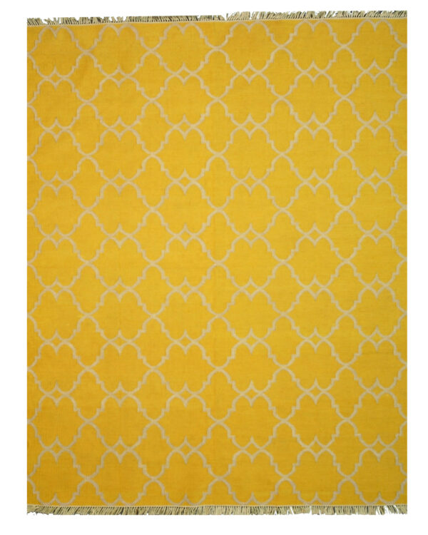 Bright yellow rug with a repeating off-white quatrefoil pattern and short visible fringe.