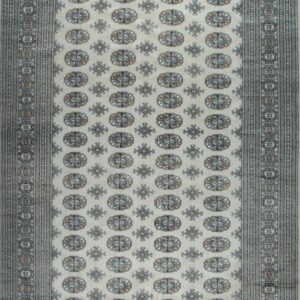 Cream area rug with repeating blue, grey, and peach geometric medallions and intricate, multi-layered borders.