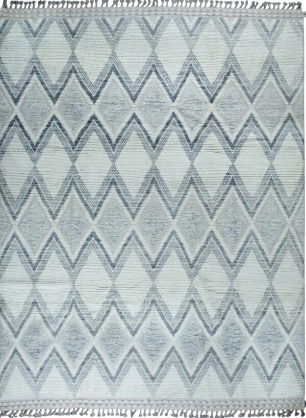Off-white textured rug features large interlocking diamond patterns in various shades of gray and blue with short tassels.