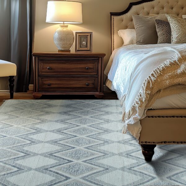 Low-pile light gray rug with textured zigzag diamond pattern placed next to a dark wood nightstand.