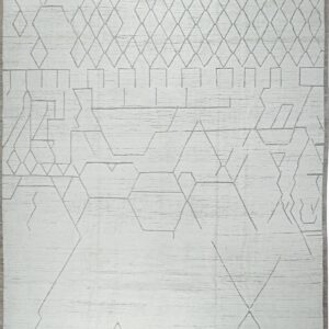 High-textured white rug featuring an abstract linear gray geometric pattern and gray fringe.