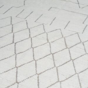 Textured cream rug with gray geometric diamond and abstract linear patterns.