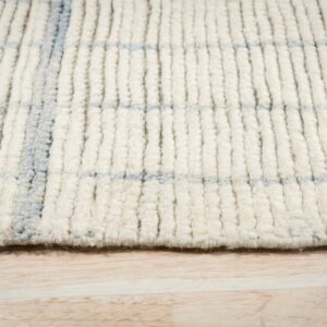 Thick shaggy cream and blue checkered rug texture resting on light wood flooring.