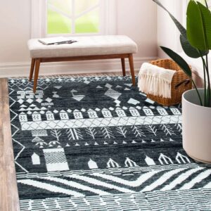 Black and white geometric rug on wood flooring next to a bench and large potted plant.