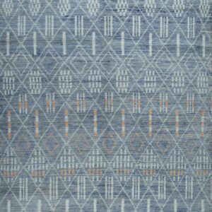 Blue geometric area rug with white diamond trellis and vertical stripe patterns, featuring subtle orange details.