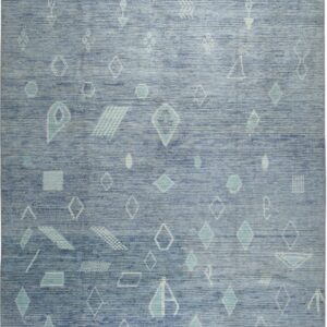 Blue textured rug featuring scattered white and teal geometric shapes, finished with gray borders and fringe.