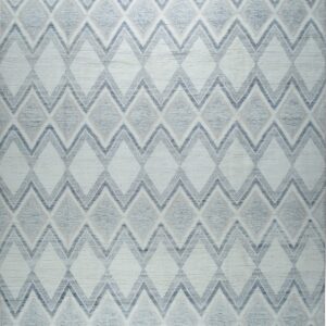 Textured white rug displaying a gray and tan zigzag diamond pattern, finished with tassels.