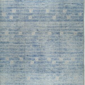 Blue rug with high-low textured stripes and light-colored geometric patterns, featuring short fringe.