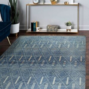 Blue geometric rug with white and tan patterns on dark wood floor near a gold console table.