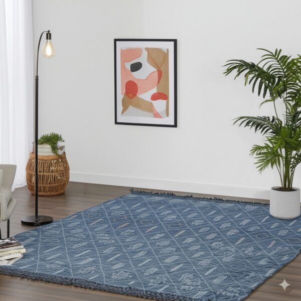 Blue textured rug featuring a light geometric diamond pattern in a room with wood floors and plants.