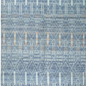 A textured blue rug displaying white geometric patterns of diamonds and vertical stripes with peach accents.