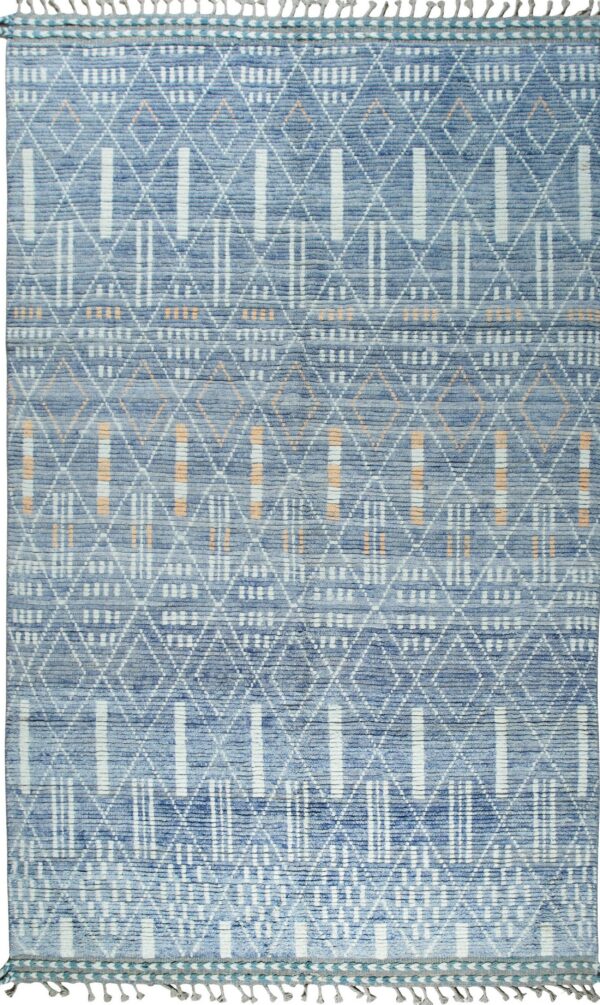 A textured blue rug displaying white geometric patterns of diamonds and vertical stripes with peach accents.
