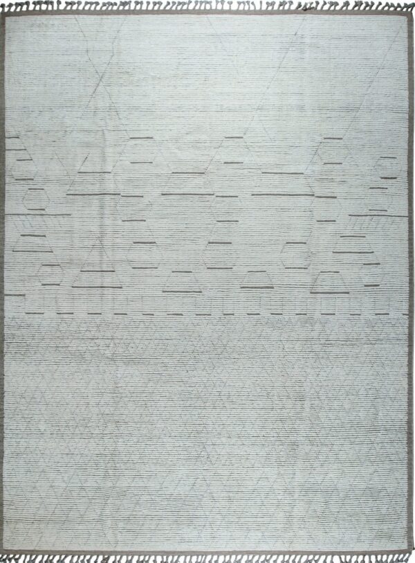 Light gray plush rug with textured horizontal rows, subtle geometric shapes, and gray tassels.