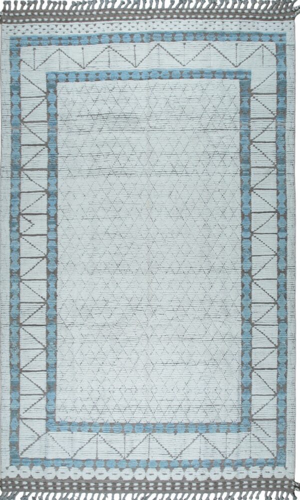 Textured white rug with light blue and gray geometric borders, a subtle diamond field pattern, and decorative fringe.
