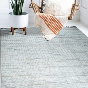 Light gray rug featuring a linear plank design, placed under a rattan chair and potted plant on white flooring.