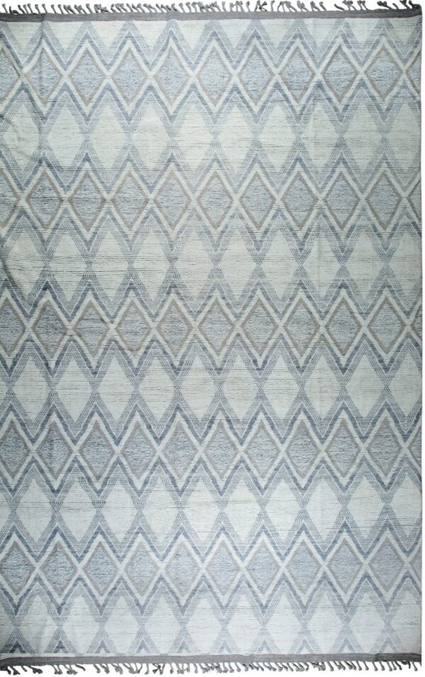 Light blue and white textured rug displaying a repeated geometric diamond and chevron pattern.