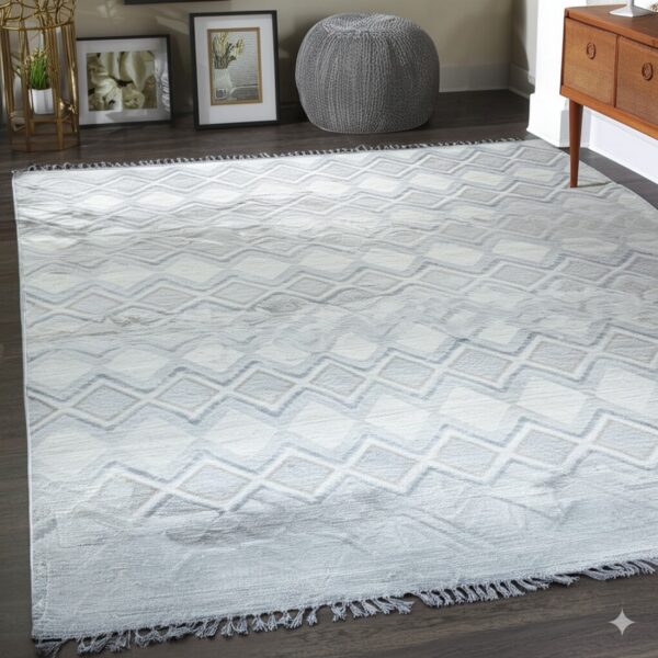 Light gray low-pile rug with a staggered diamond pattern and short fringe on dark wood flooring.