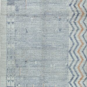 Textured off-white rug with a dense blue grid pattern, orange accents, and wide chevron border.