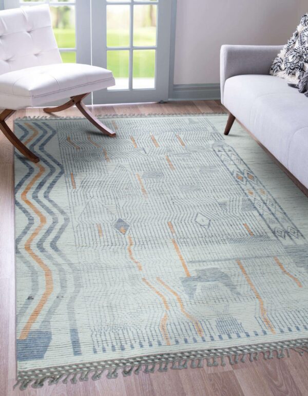 Low pile rug featuring blue and orange zigzag and grid patterns between a white chair and gray sofa.