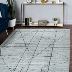 Light gray textured rug with black geometric lines lays on a dark wood floor near a gold console.